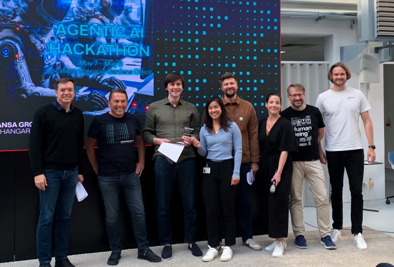 Shirley He holding the winner's award with her team at the Lufthansa Group Digital Hangar Agentic AI Hackathon